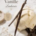 Un pot de glace vanille Ladurée avec une cuillère à côté, sur une table élégante.